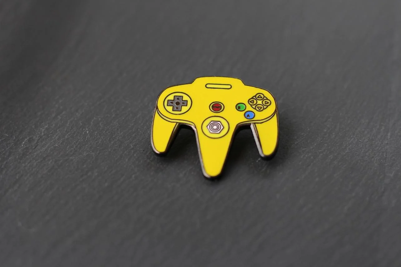 Real Sic: N64 Video Game Controller Enamel Pin - Yellow